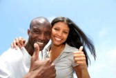 9784639-cheerful-couple-showing-thumbs-up